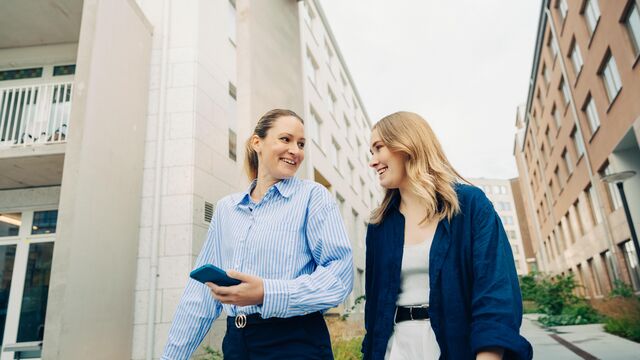 Two woman in walk-and-talk urban environment - small